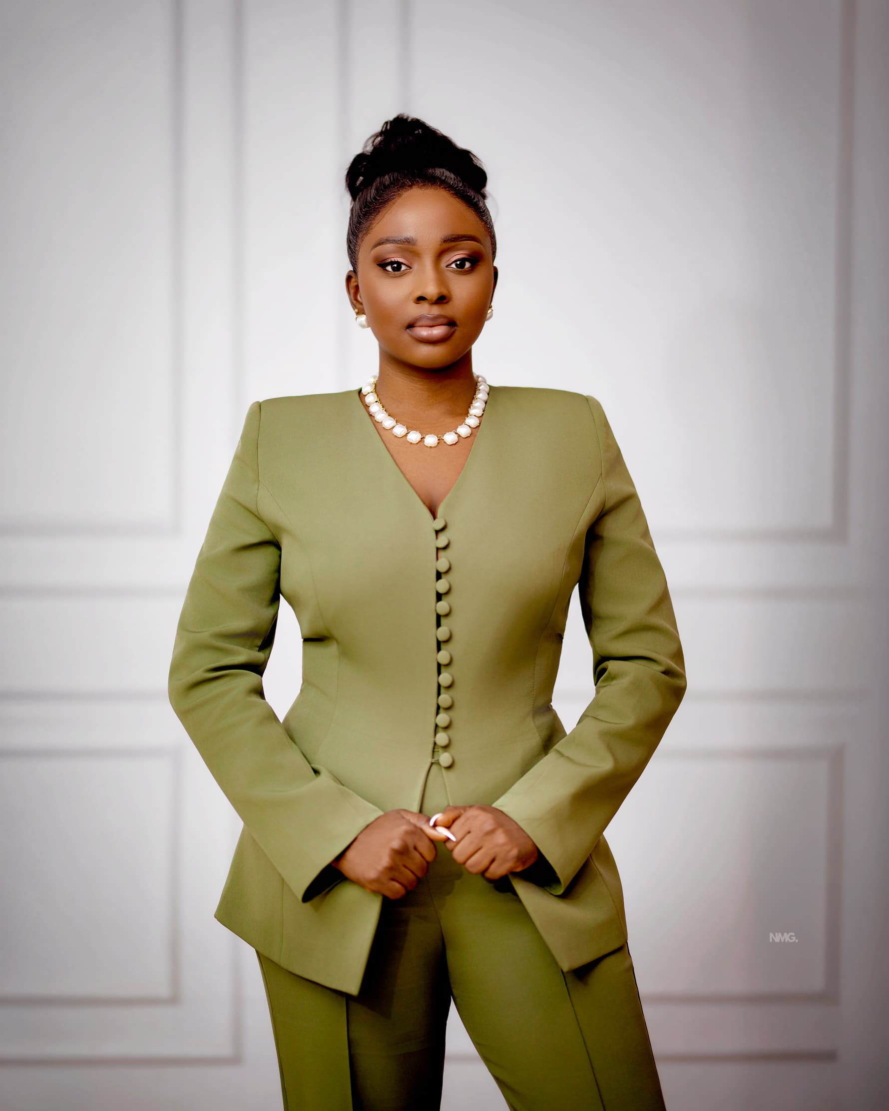 Jennifer Ibrahim in an olive suit